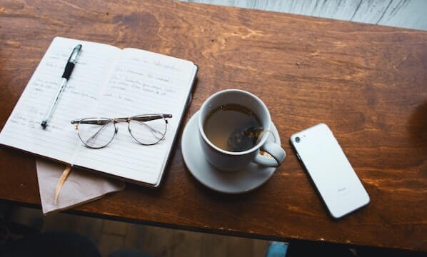 Note pad, glasses, phone